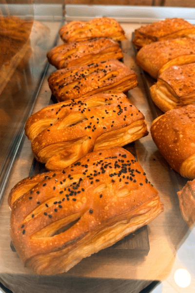 Sin-titulo-11-de-junio-de-2026-a-las-19.22.18-7 Freshly baked puff pastry with black sesame seeds at our Tampa bakery