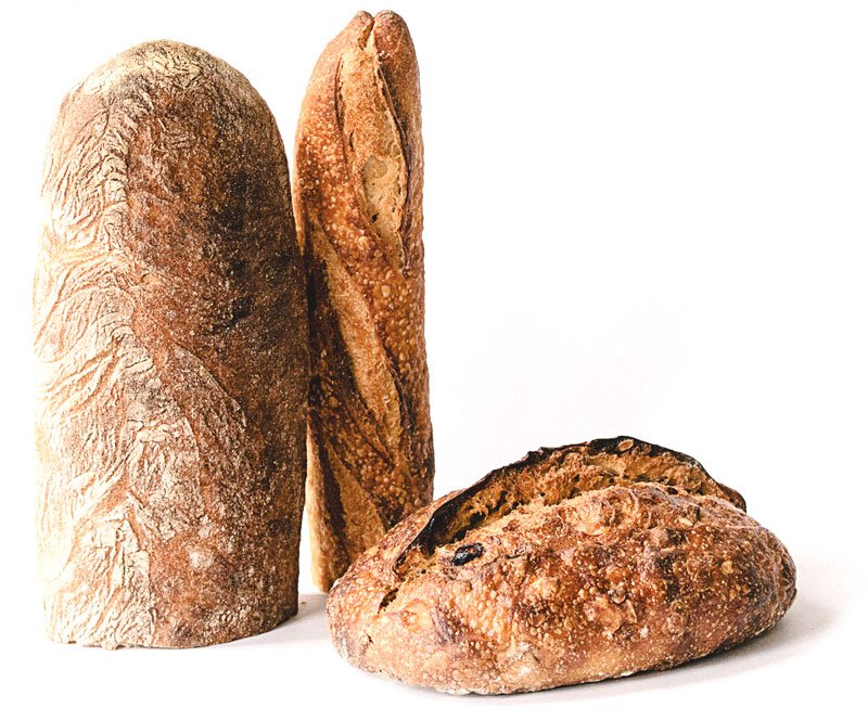 Sourdough loaves and a baguette baked fresh daily at our Tampa bakery